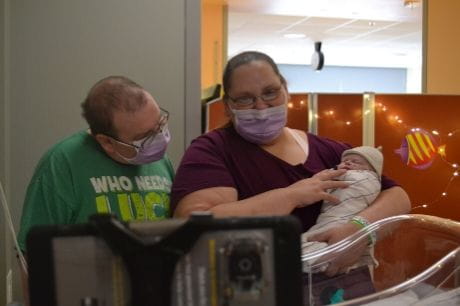Parents hold their newly baptized baby in the Geisinger NICU.