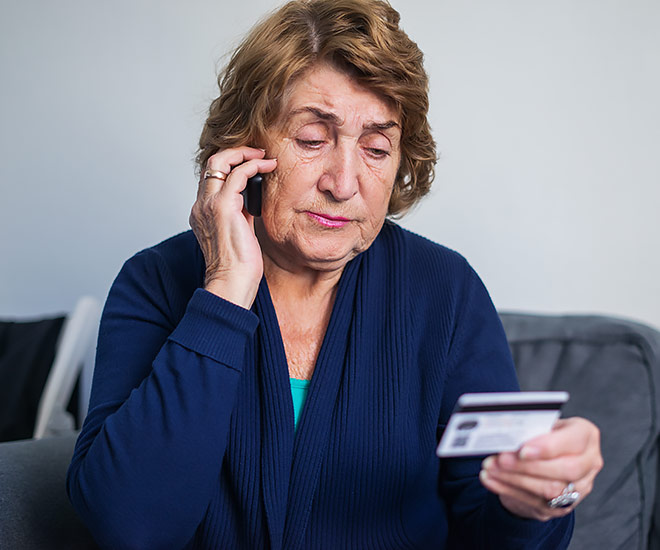 Woman providing credit card information over the phone.