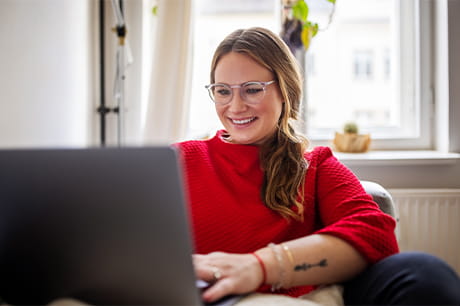 Woman in red sweater on computer