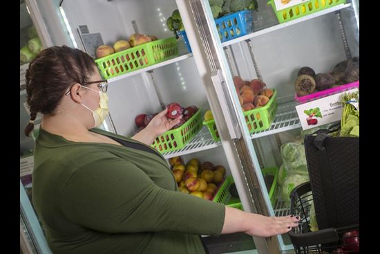 a woman shopping for food at the Fresh Food Farmacy