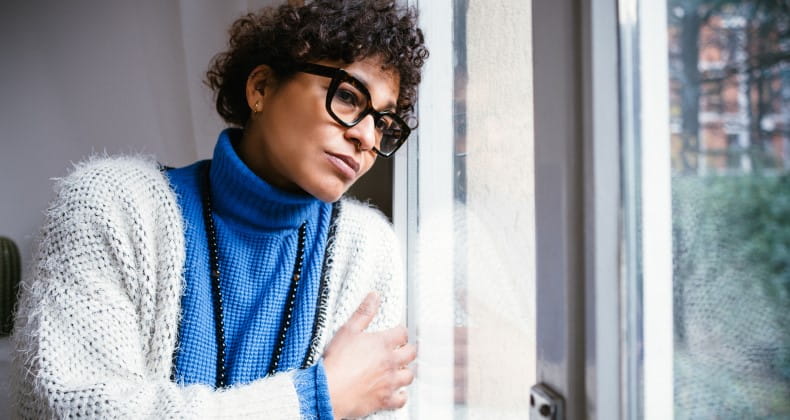 sad woman looking out of window