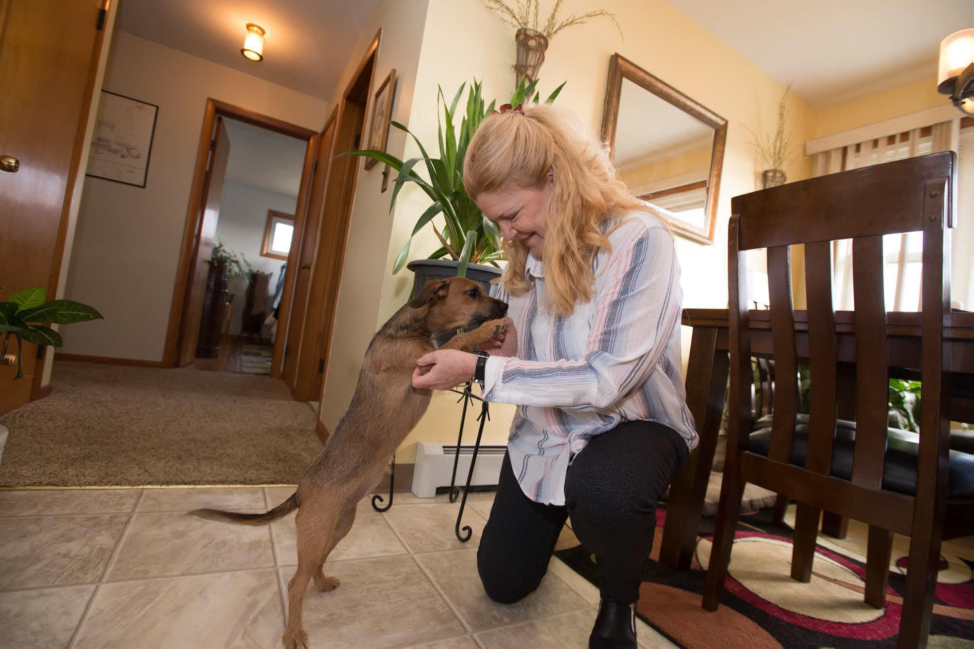 Rosanne plays with her puppy after a full hip replacement with Mako® robotic-arm–assisted joint replacement surgery.