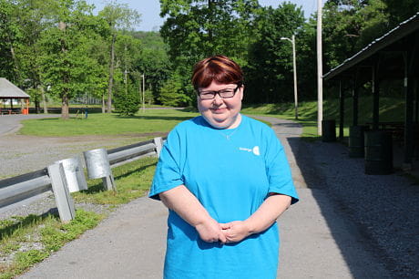 Jenn Kauffman, standing and smiling, during the 13th annual Walk in the Park for Arthritis. 