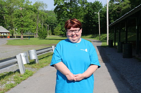 Jenn Kauffman, standing and smiling, during the 13th annual Walk in the Park for Arthritis.