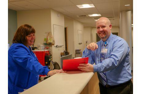 Nurse Dawn Erfman and chief advanced practitioner Bret Stemrich review a file in the Geisinger Kingston Clinic.