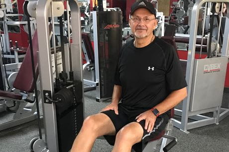 Bob Romanaskas demonstrates the sturdiness of his two new knees on some gym equipment.