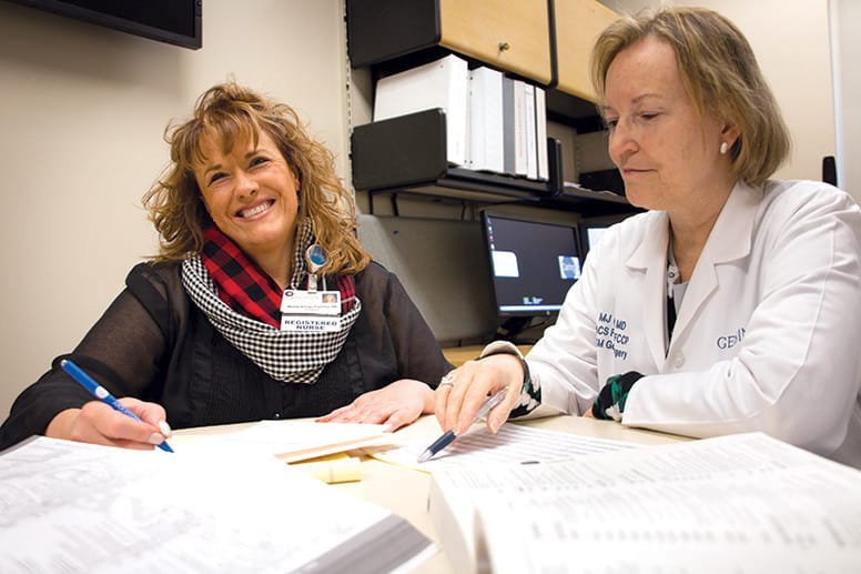 Wendy Baloga-Truschel and two physician advisors review a CDI chart. 