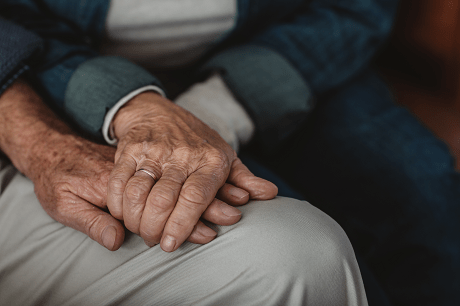 Older couple holding hands