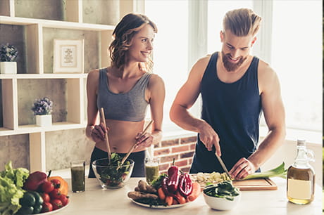 People in kitchen with healthy food
