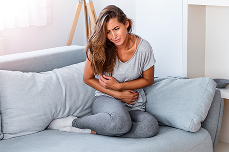 Woman in with stomach ache