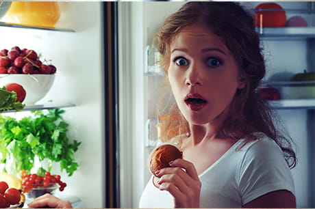 Women looking surpised at refridgerator