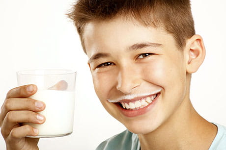 Smiling boy with milk mustache