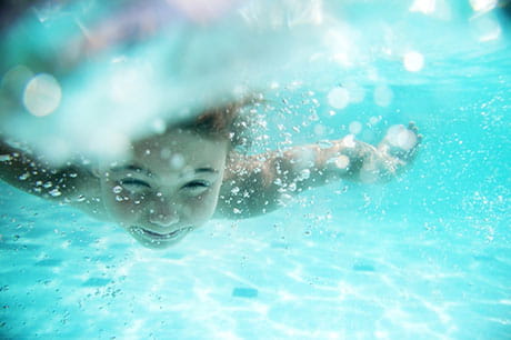 child swimming underwater