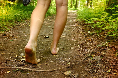 Walking barefoot on dirt path