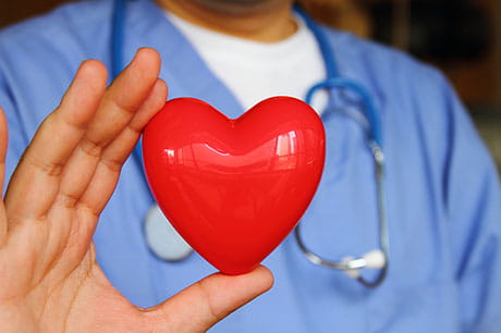 doctor holding heart prop