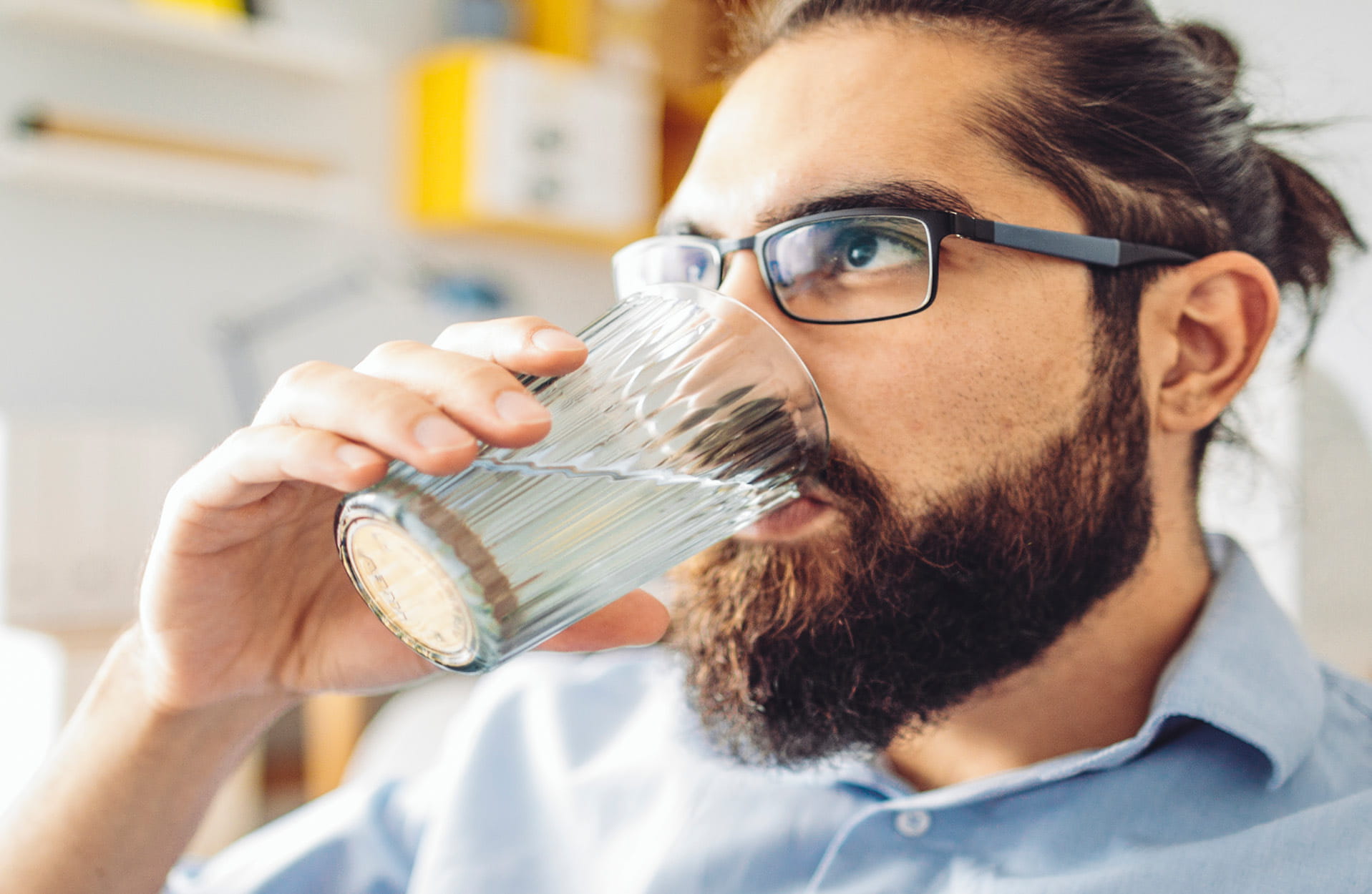 A man drinking a glass of water