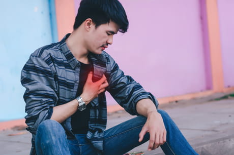 Man clutching chest