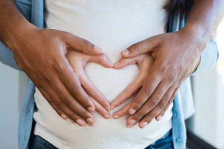 Parents holding a pregnant stomach