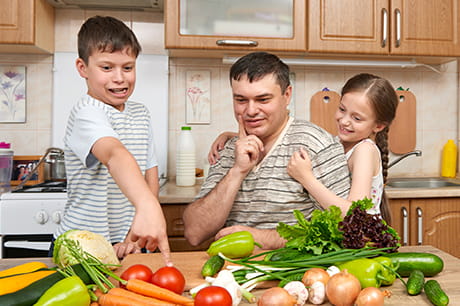 Kids choose vegetables with their father