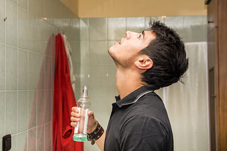 Man rinsing his mouth with mouthwash.