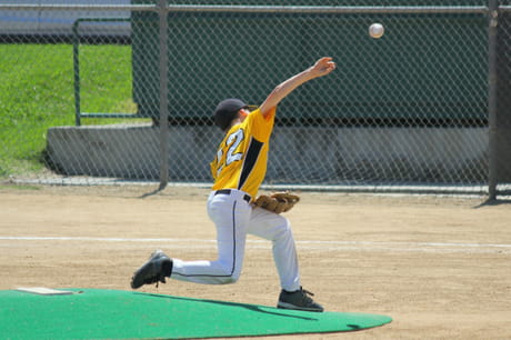 Kid throws a baseball
