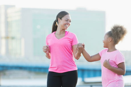 Mom and daughter holding hands and walking