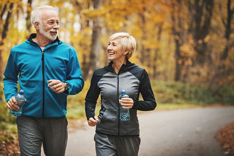 Happy couple exercising regularly to prevent stroke.