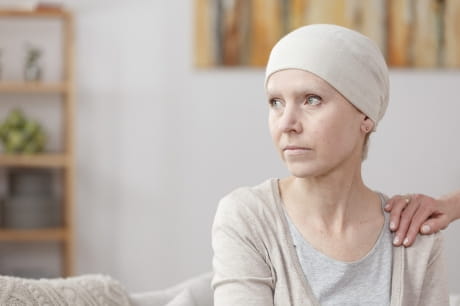 Woman looking out of frame with cancer diagnosis.