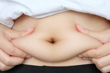 Person holding belly fat