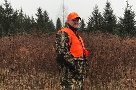 A hunter in orange hunting gear