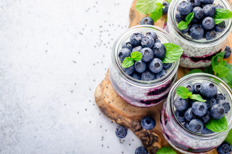 Greek yogurt parfait topped with fresh blueberries.