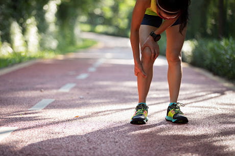Woman runner experiences pain from shin splints