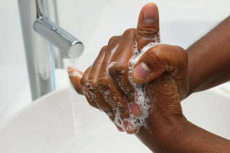 A man washing his hands to protect himself against flu and other illness.