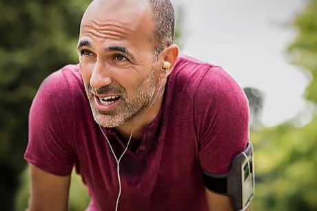 Man catching his breath after a run to combat stress