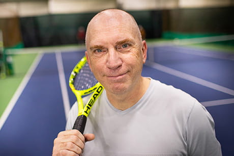Middle-aged man now pain-free after vascular surgery and able to play tennis again