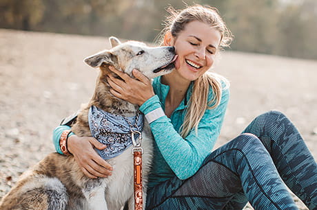 woman with urinary incontinence enjoying time outdoors with her dog