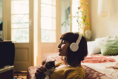 Young adult listening to music while being quarantined at home due to coronoavirus