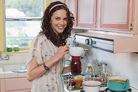 Young lady canning jelly and other foods