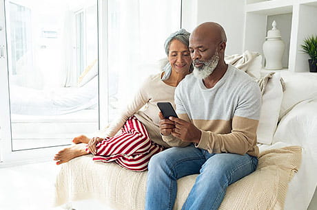 Middle-aged couple looking at health information online