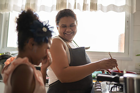 Mother and daughter cooking in the kitchen