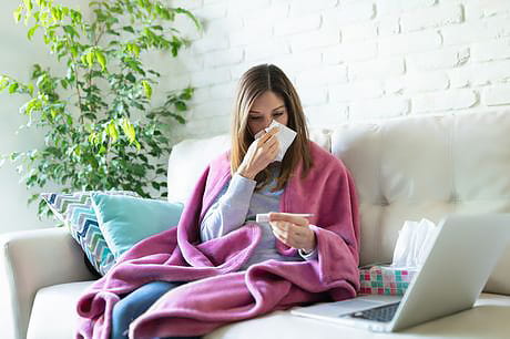 Woman with coronavirus symptoms researching virus