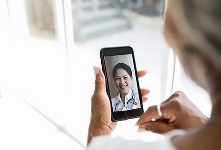 Female patient on a telemedicine call with her physician