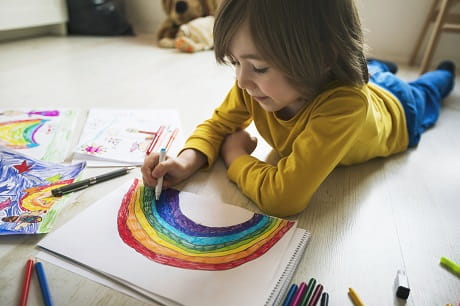 Child drawing a rainbow