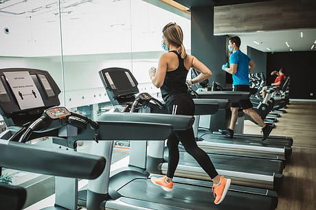 Runners at the gym wearing masks to prevent the spread of Coronavirus.