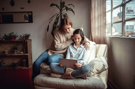 Mom and young daughter using a tablet together