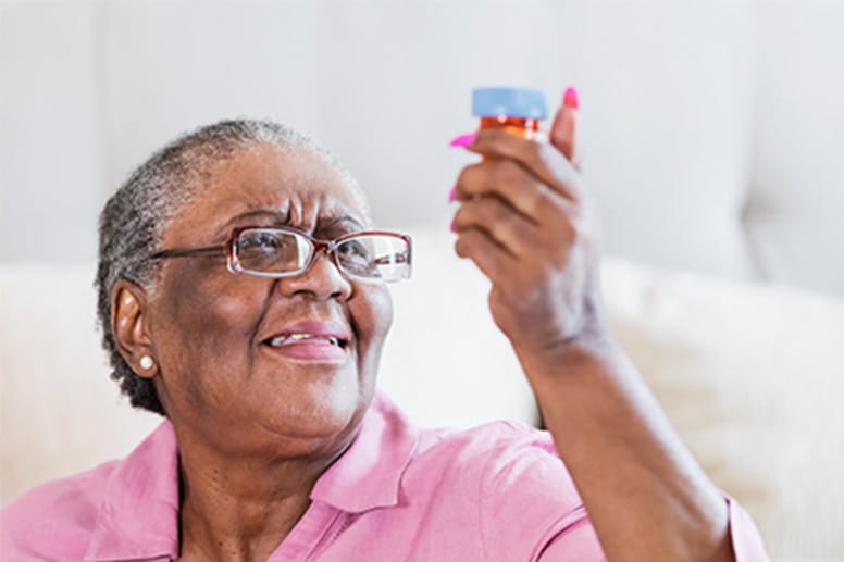 Senior lady looking at her medication