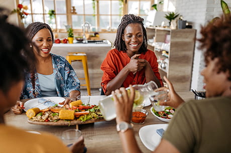 Family sitting down eating a healthy meal