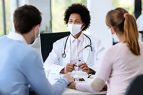 Couple discussing fertility options with a reproductive endocrinologist.