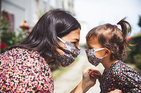 A mom & daughter wearing masks