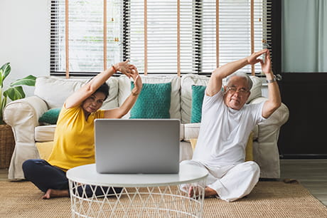 Senior couple stretching at home
